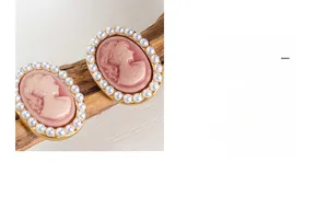 Detail of vintage cameo earrings with pink oval portraits and faux pearl borders