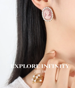 Detailed view of vintage cameo pearl earrings and multi-layered gold pearl ring set