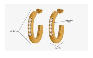 Detailed view of U-shaped gold earrings with white pearls and size measurements