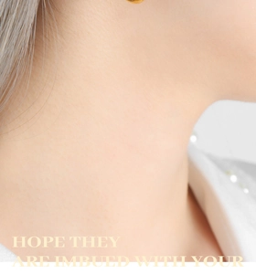 Close-up of golden U-shaped titanium steel earring on ear with minimalist french style