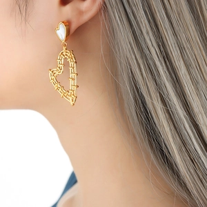 18K gold heart earrings with white shell inlay on model, boho style jewelry for women