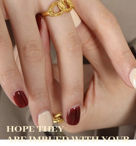 Macro detail of minimalist 18K gold plated chain ring on hand with text overlay