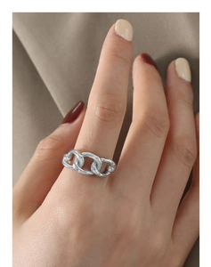 Close-up of minimalist silver chain link ring in titanium steel on model finger