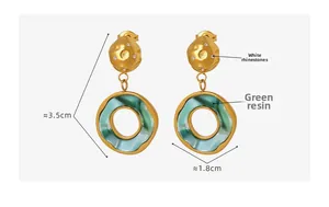 Detail of 18K gold earrings with green resin pendants and rhinestones, size 3.5cm x 1.8cm