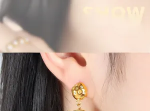 Detail of 18K gold geometric earring with green resin and sparkling rhinestones