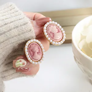 Pink cameo earrings with simulated pearls and 18K gold plating for a vintage aesthetic