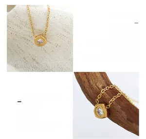 Detailed macro view of 18K gold plated meteorite pendant with sparkling white zircon