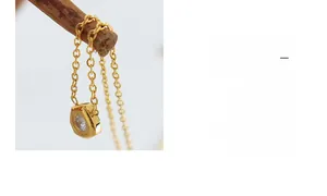 Detailed close-up of golden necklace with meteorite pendant and zircons on branch