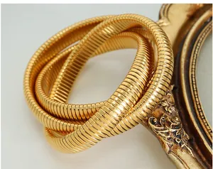 Macro shot of 18k gold plated stainless steel triple layer snake chain bracelet on mirror