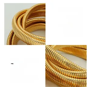 Detail of 18K gold plated triple-layer snake chain stretch bracelet in titanium steel