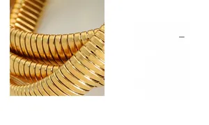Detail of multi-layer gold-plated stainless steel snake chain bracelet with textured finish