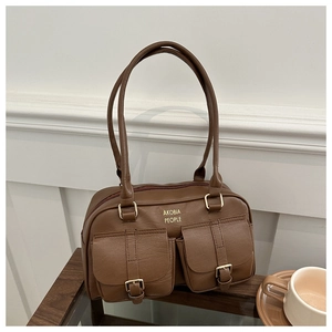 Detail of brown faux leather handbag showing vintage dual front buckle pockets and gold logo