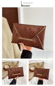 Detail of brown faux snake skin texture and gold metal trim on elegant envelope clutch