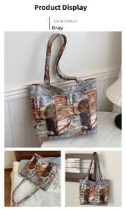 Detail of gray tote bag with denim and leather print texture and contrast stitching