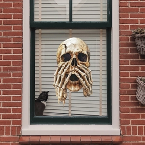 Retro cracked skull window sticker for Halloween decoration on a red brick house window