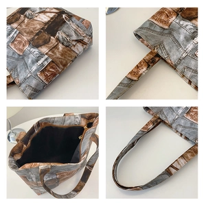 Detail view of denim tote bag showing stitching, reinforced handles and inner zipper pocket