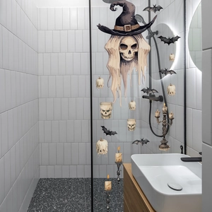 Halloween skull and bat window clings applied on a glass shower door for festive decor