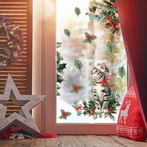 Detail of Christmas cat window sticker with holly leaves on festive glass backdrop