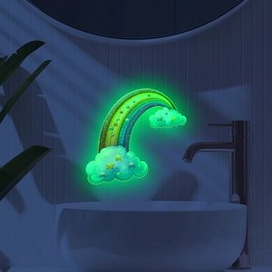 Luminous rainbow and clouds wall decal glowing green in a dark bathroom setting