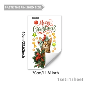 Detailed view of Christmas window sticker showing a tabby cat with green bow and holly