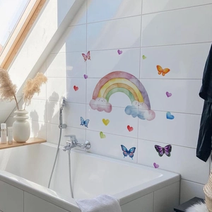 Detailed view of watercolor rainbow and cloud wall stickers in a bright bathroom setting