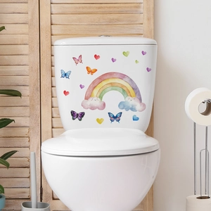 Detailed view of watercolor rainbow, butterflies, and heart wall stickers on a clean bathroom wall