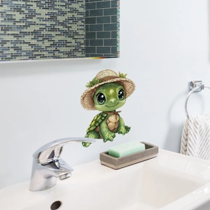 Detail of cute green turtle wall sticker with straw hat on white bathroom wall tile
