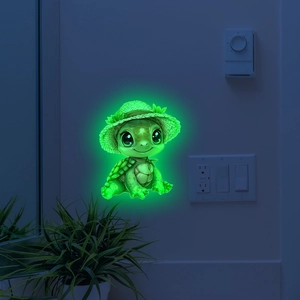 Luminous turtle wall sticker with straw hat glowing green in a dark bedroom setting