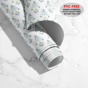 Detail of PVC-free floral wallpaper rolls with eco-friendly hydrosol adhesive on marble