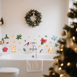 Detail of watercolor Christmas window stickers with gingerbread and holly on white tiles