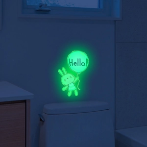 Luminous wall sticker showing a cute glowing rabbit holding a Hello balloon in dark