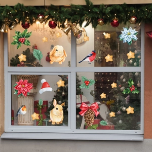 Close-up of hand-painted Gingerbread Man and Christmas stickers on a window glass pane