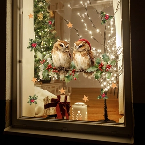 Detail of Christmas window decals featuring hand-painted owls and festive holly motifs