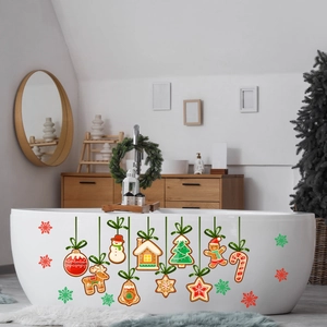Detailed view of gingerbread Christmas window decals on a smooth bathroom surface