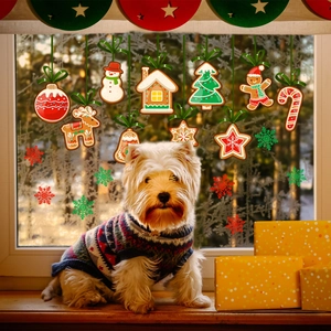 Cozy scene of a white dog by a window decorated with gingerbread man Christmas decals