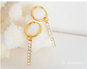 Macro shot of 18K gold plated drop earrings with vertical bar set with white cubic zirconia