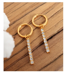 Detailed shot of 18K gold-plated drop earrings featuring vertical rows of cubic zirconia
