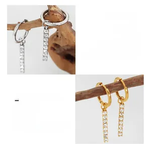 Detailed macro view of 18K gold plated surgical steel earrings with cubic zirconia stones