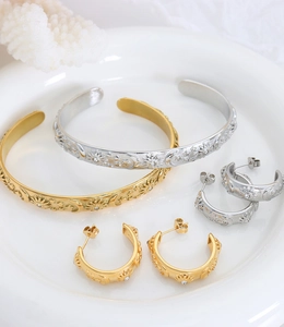 Detailed set of gold and silver bangles and earrings featuring celestial sun moon motifs