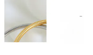 Macro detail of gold and silver tubogas snake chain texture with polished finish