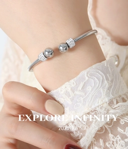 Close-up of silver steel cuff bracelet with mirror beads and paved zircon accents