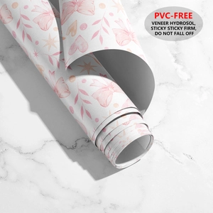Detail of PVC-free wallpaper roll with pink bows, hearts, and stars pattern for walls