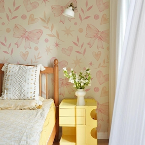 Detail of pink watercolor wall stickers with butterflies and botanical elements in a bedroom