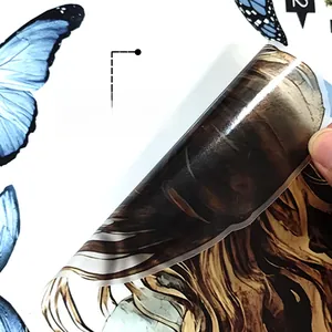 Detail of self-adhesive wall sticker backing showing the blue butterfly design and peel-off layer