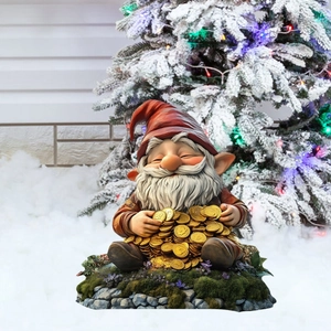 Detail of a Christmas gnome garden stake holding gold coins on snowy festive background
