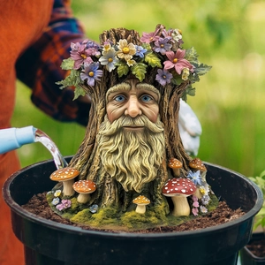 Garden gnome tree stump face statue with colorful flowers and mushrooms in a flowerpot