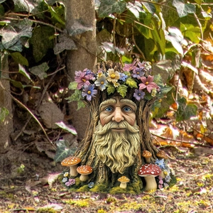 Macro detail of gnome tree spirit garden stake with colorful flowers and red mushrooms