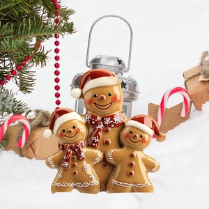 Detail view of festive gingerbread man family garden stakes in a snowy Christmas scene
