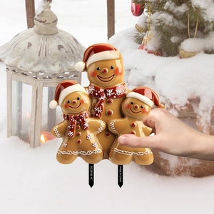 Outdoor gingerbread family garden stake decoration featuring colorful festive patterns