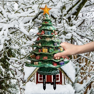 Detailed view of a green Christmas tree garden stake with colorful gift box accents